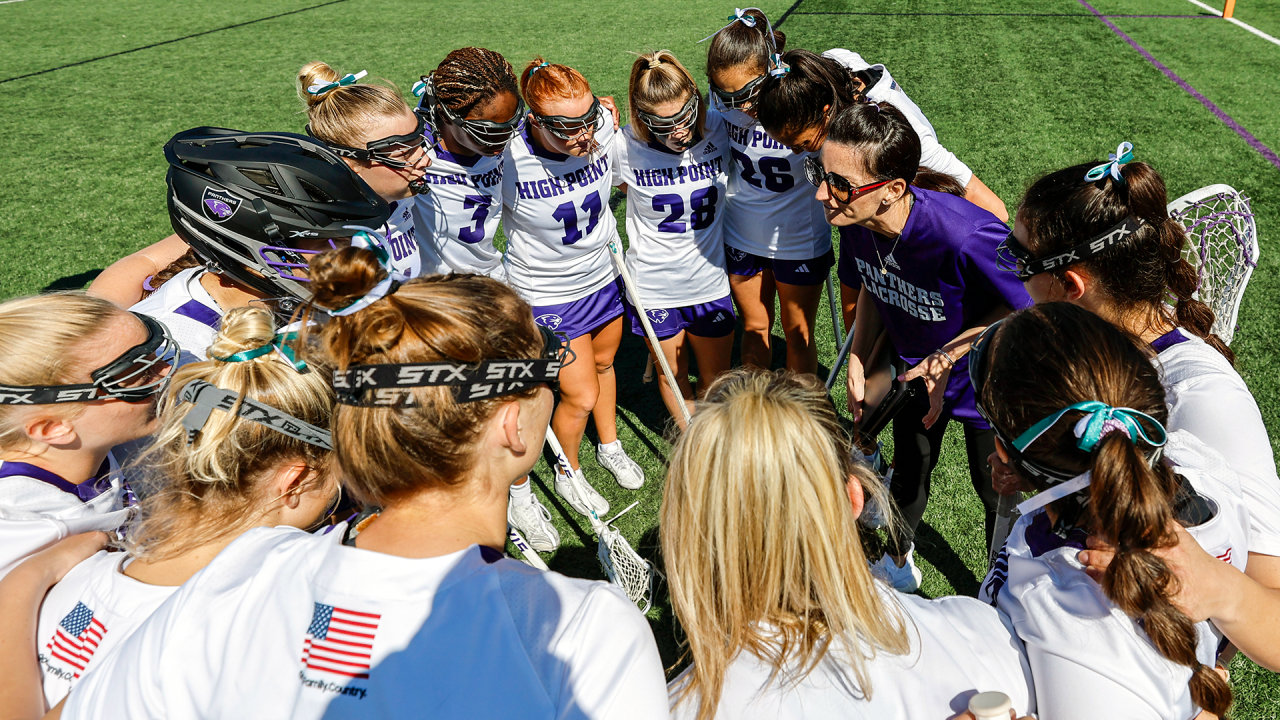 Coach Lyndsey Boswell with her High Point women's lacrosse team